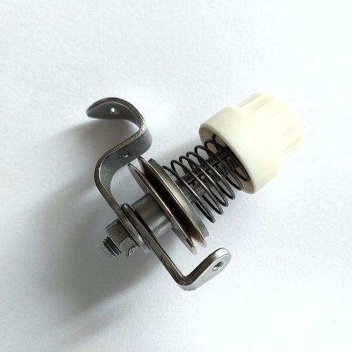 Textima fedőző szálfeszítő egység